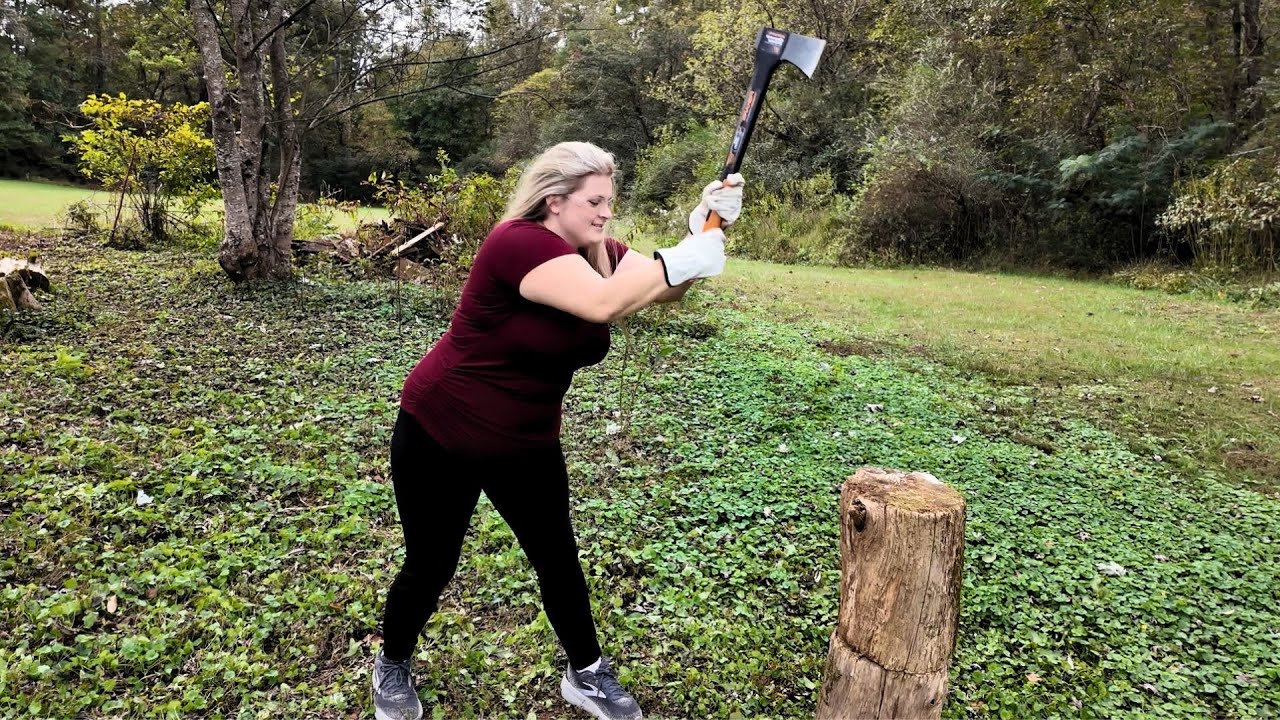 Bree splitting firewood with an axe